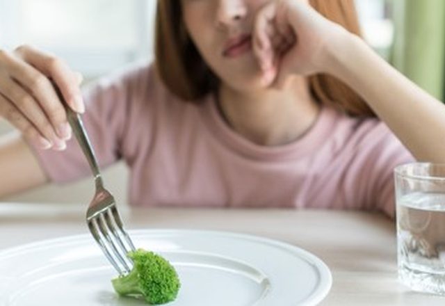 A person at a table with a meal